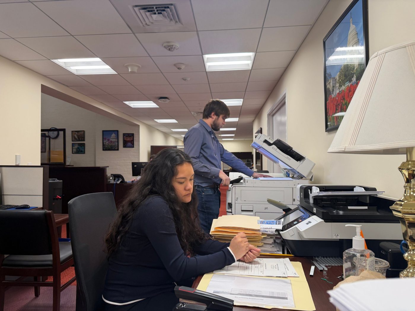 Two students copying and logging franking records at the Legislative Resource Center